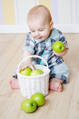 Fototapeta premium little boy with a basket of apples