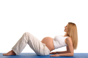 Fototapeta premium pregnant woman lying down and practicing yoga