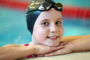 Fototapeta premium Portrait of girl swimmer in swimming pool