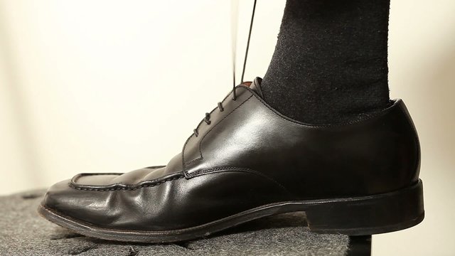 Man's hands tying shoes