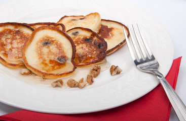 pancakes on a plate with honey and nuts