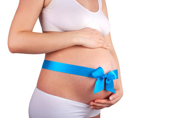 Pregnant belly with blue ribbon