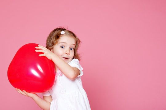 Girl Playing With Red Balloon