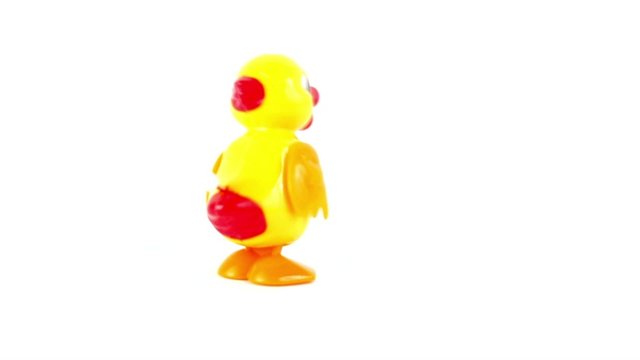Clockwork yellow toy chicken shaky walk by circle few times