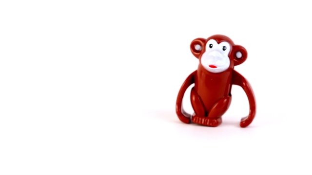 Clockwork toy monkey sideway walk from right to left