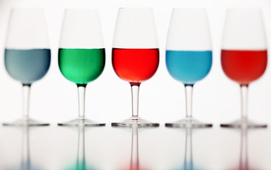 defocused glasses of colored liquid