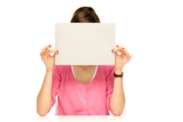 Girl covering her face with blank board