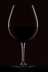 red wine in glass on black