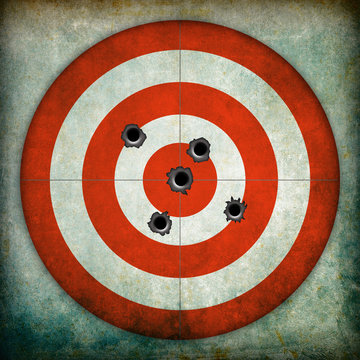 Target with bullet holes, grunge background