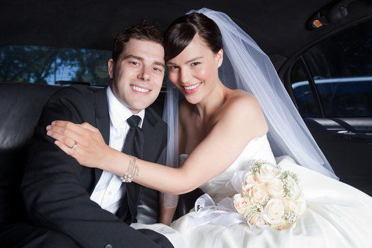 Happy Wedding Couple in Limo