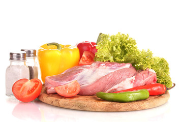 Raw meat and vegetables on a wooden board isolated on whitе