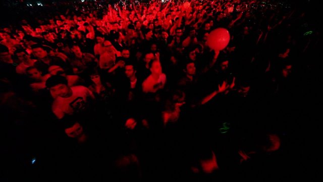 Lot of people dance at rave party