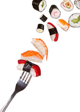 Sushi pieces falling on fork, isolated on white background
