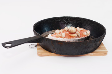 Cooking salmon steaks in a frying pan
