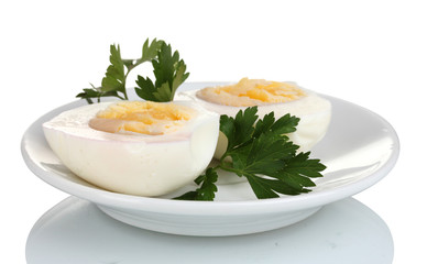 tasty boiled eggs and parsley on plate isolated on white