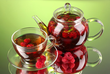 Black fruit raspberry tea in glass teapot and cup