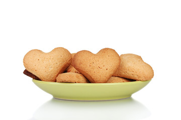 Heart-shaped cookies on green plate isolated on white