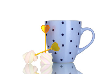 Two marshmallows with skewers and cup isolated on white