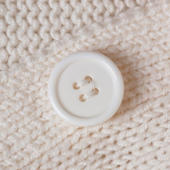 High Resolution knitted texture with a white button background