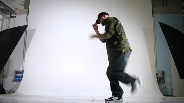 Guy-rapper poses for photographer in studio