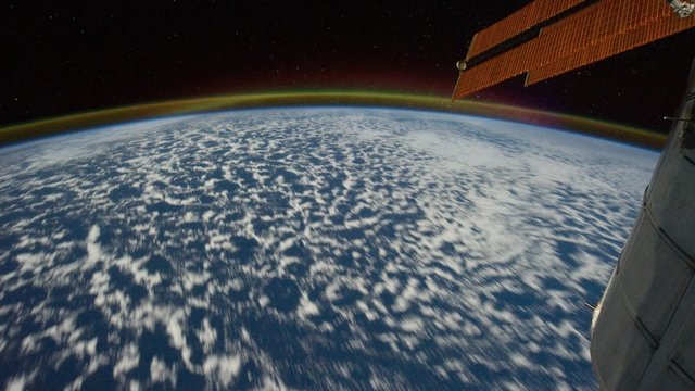 Planet Earth is cover by clouds visible from shuttle window