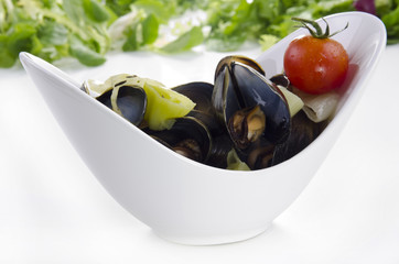 Cooked mussels with garlic butter sauce and tomato