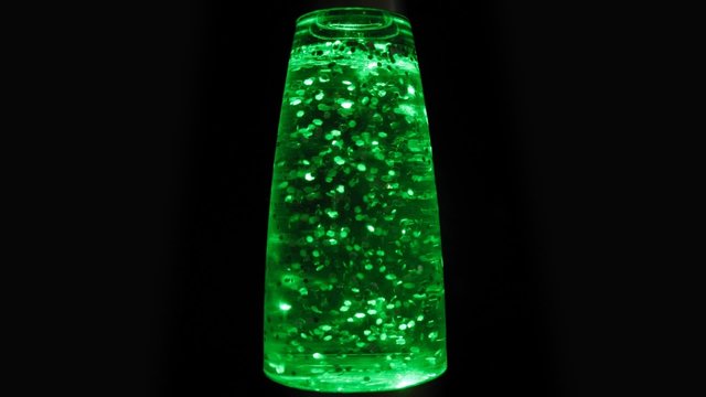 Nightlamp with flying particles stand on black background