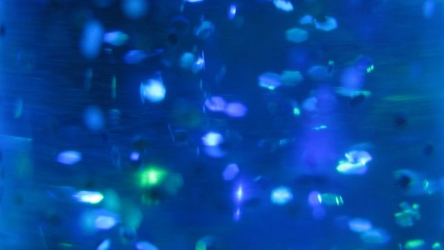 Particles in night lamp fly and shine different colors
