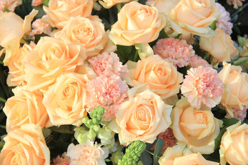 Soft orange roses and carnations