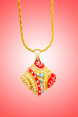 Golden jewellery against gradient background