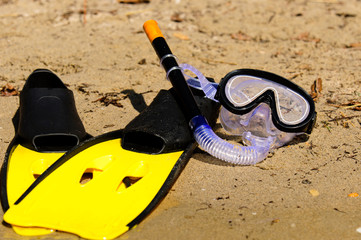 Goggles and flippers on the shore