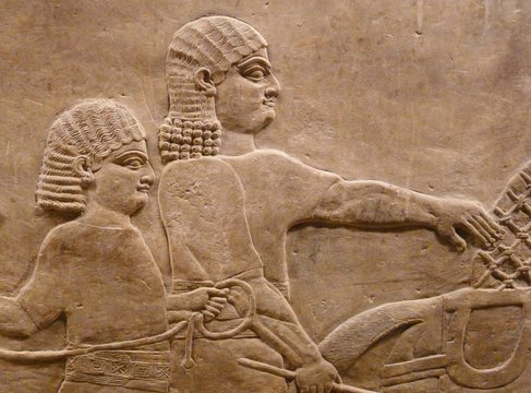 Ancient Assyrian wall carving of men
