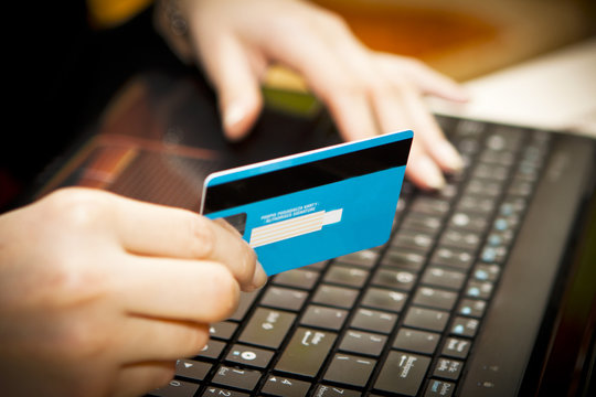 Online shopping with credit card on laptop