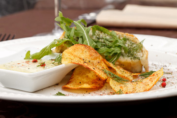 fish pie with sauce and potato chips