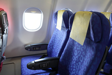 Airplane blue seat and window inside an aircraft