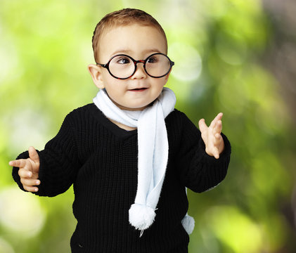 portrait of adorable kid wearing glasses gesturing doubt against