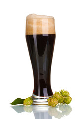 dark beer in a glass and green hop isolated on white