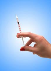 Hand holding syringe isolated on the white