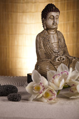 Buddha statue with orchid flower