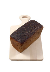 Black bread on a wooden board isolated on  white