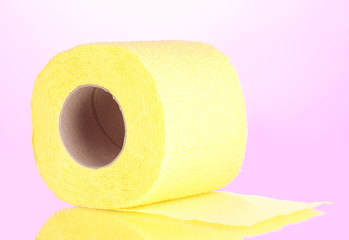 yellow roll of toilet paper on pink background