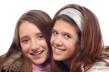 Portrait of two beautiful teenage girls smiling