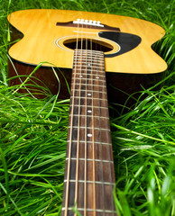 Acoustic guitar in green grass