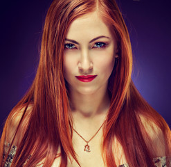 Portrait of attractive young female with fiery hair