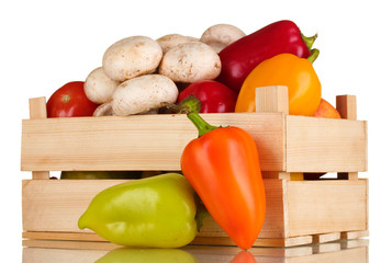 fresh vegetables in wooden box isolated on white
