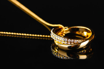 Pendant in form of rings with gem on black