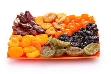 delicious dried fruits on plate isolated on white