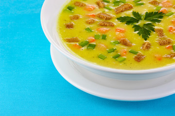 Tasty soup on blue tablecloth isolated on white