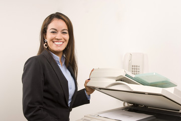 Pretty businesswoman making copies