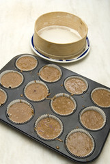 Raw dough into muffins in the forms